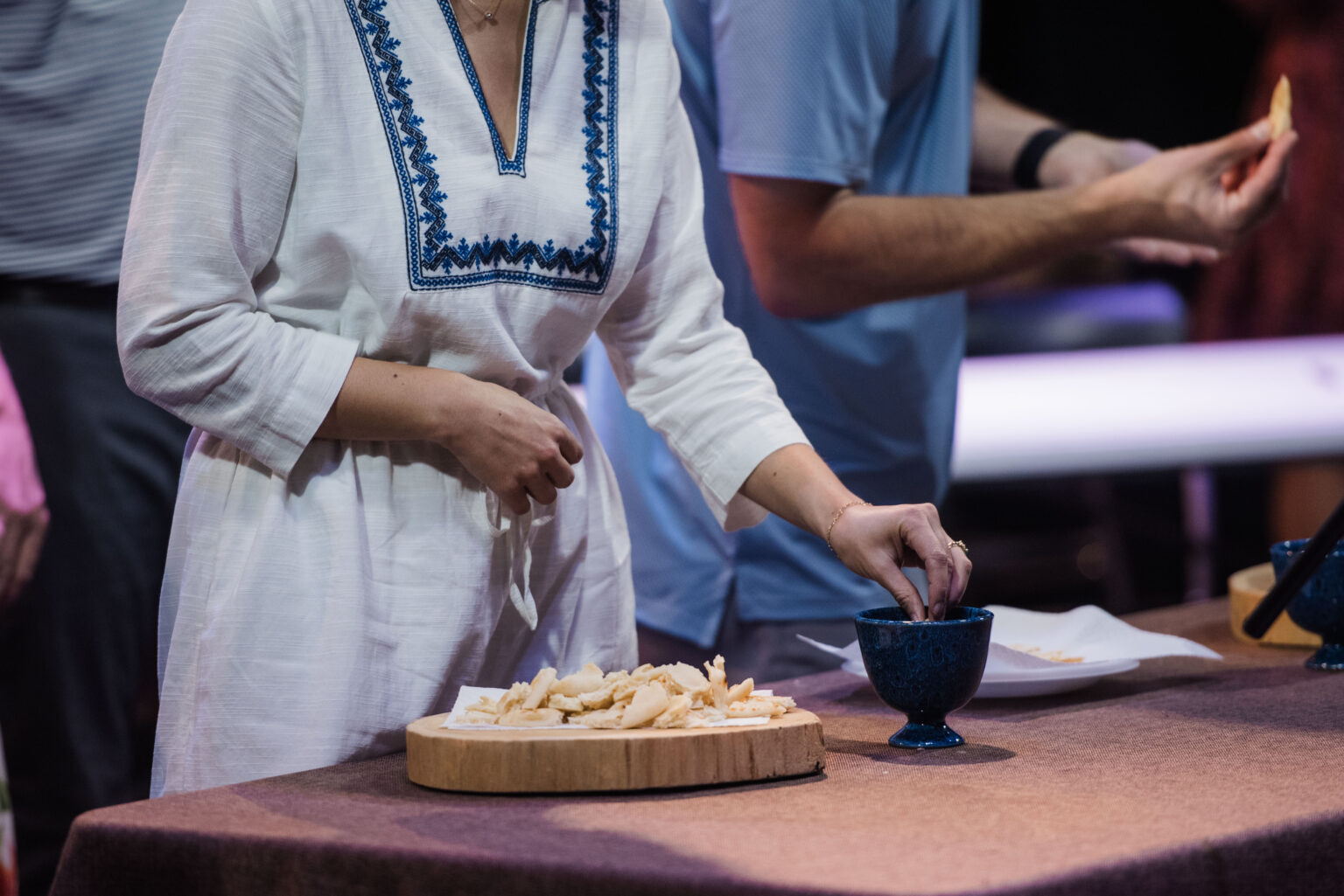 A member receiving communion at a table during Sunday worship