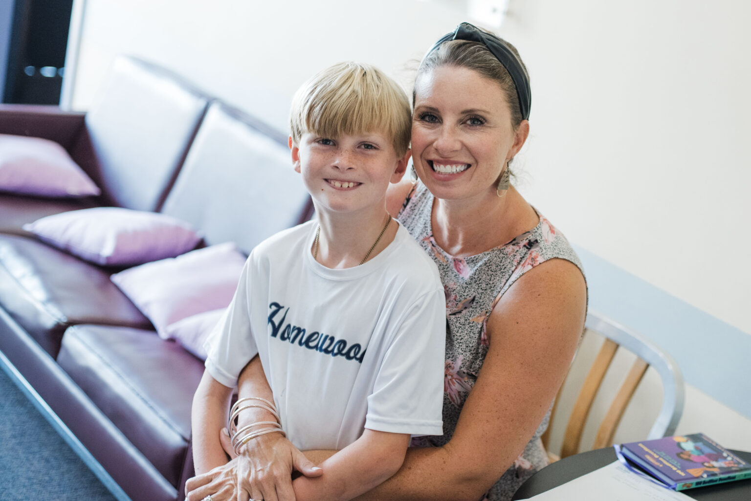 Two members smiling together during a Sunday gathering