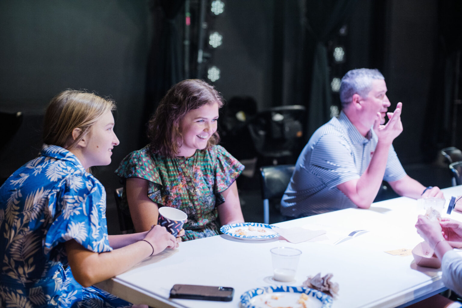 Members of Haven Field sharing a meal and conversation around a table after worship